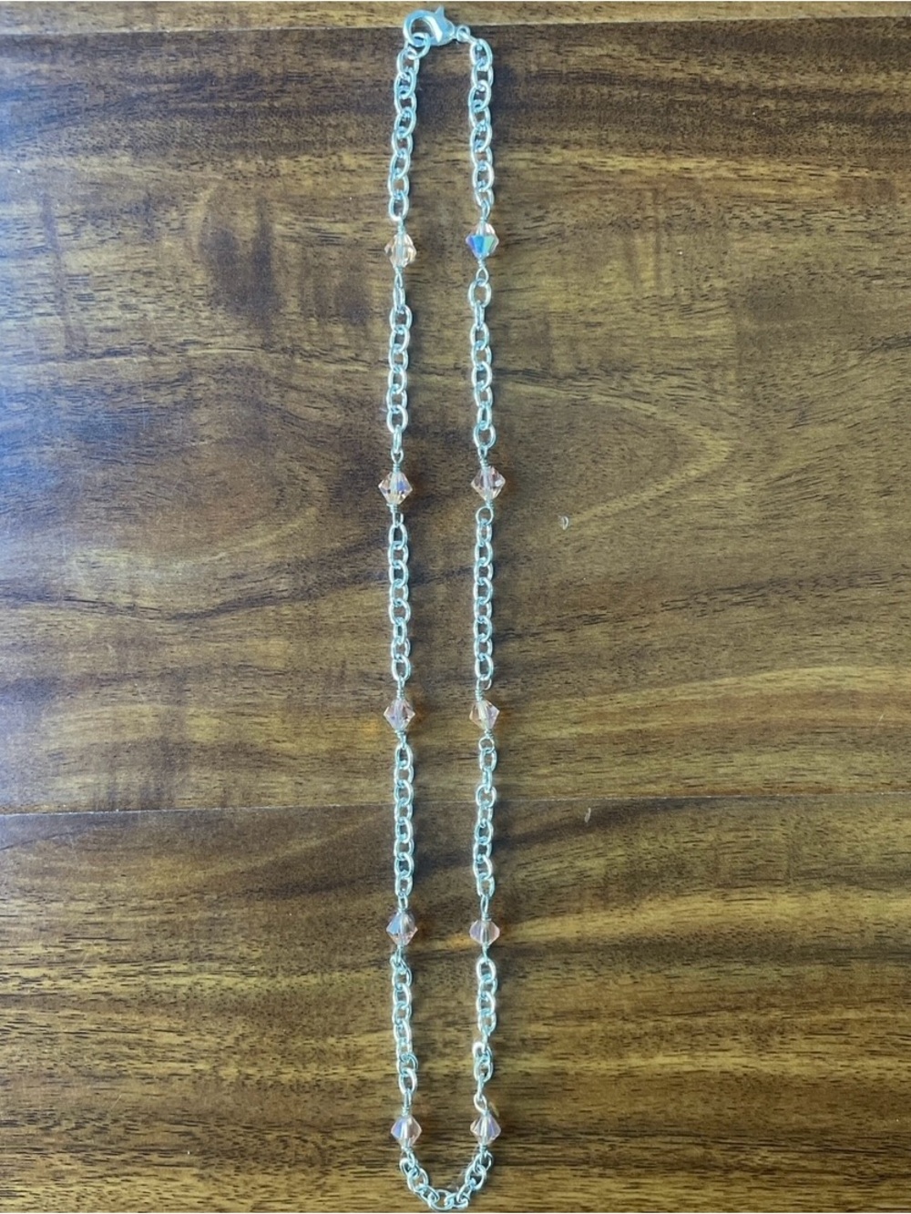 Silver chain necklace with orange beads